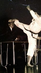 Black and white photo of Yoosun Lee performing a high side Kick